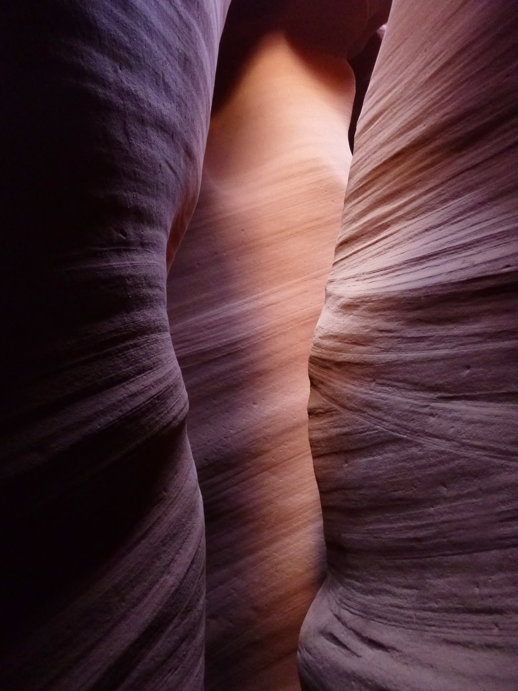 Glowing narrow slot-canyon walls on a Blue John canyoneering descent