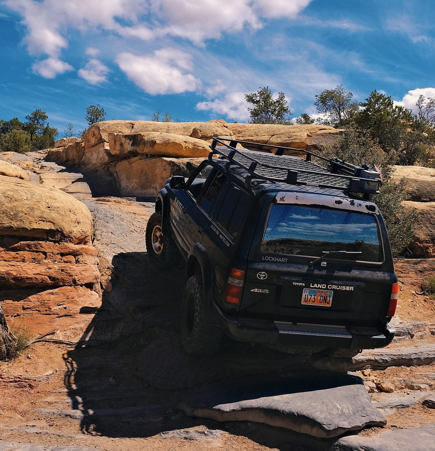 A NAVTEC 4x4 tour crossing red-rock backcountry near Moab